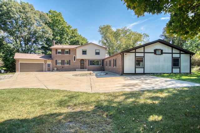 610 Birch St, Big Rapids, MI 49307 - view of front facade featuring an attached garage, a front lawn, brick siding, a chimney, and concrete driveway
