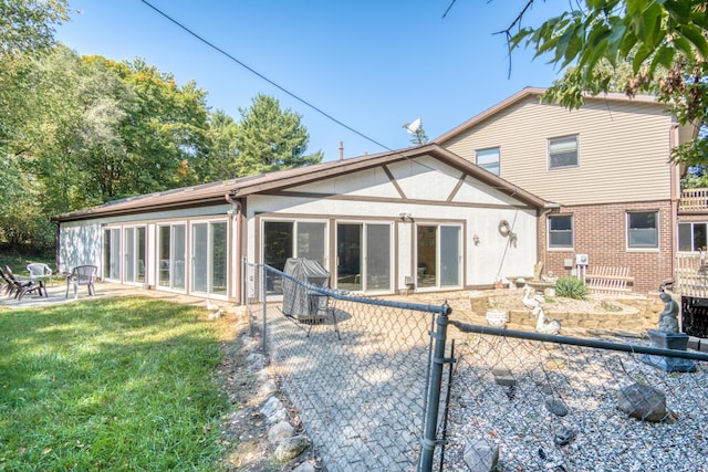 610 Birch St, Big Rapids, MI 49307 - back of property with a fire pit, stucco siding, and a patio area
