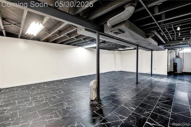 32601 Grinsell Dr, Warren, MI 48092 - finished below grade area featuring gas water heater, baseboards, and dark marble finish flooring