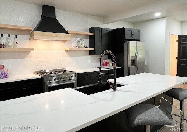 3461 Sheridan St, Detroit, MI 48214 - kitchen featuring stainless steel appliances, open shelves, dark cabinetry, premium range hood, and recessed lighting