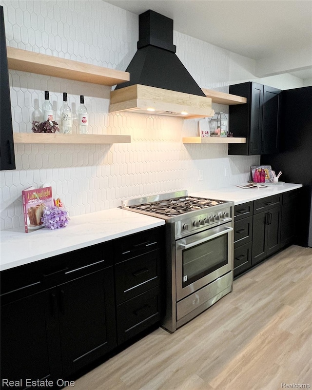 3461 Sheridan St, Detroit, MI 48214 - kitchen with open shelves, high end stainless steel range oven, dark cabinets, and custom range hood