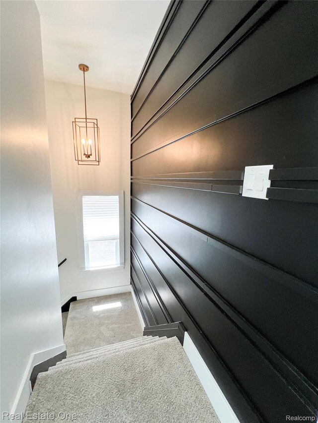 3461 Sheridan St, Detroit, MI 48214 - staircase featuring baseboards, a chandelier, and carpet floors