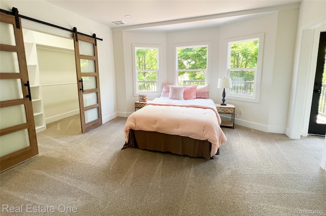 3461 Sheridan St, Detroit, MI 48214 - bedroom with a barn door, carpet floors, and baseboards