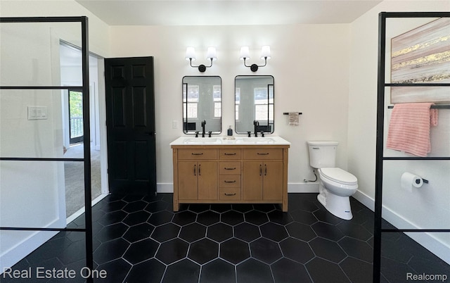 3461 Sheridan St, Detroit, MI 48214 - full bath featuring double vanity, toilet, tile patterned floors, and baseboards