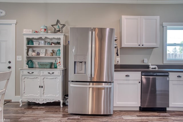 703 W Main St, Durand, MI 48429 - kitchen with appliances with stainless steel finishes, white cabinets, and wood finished floors