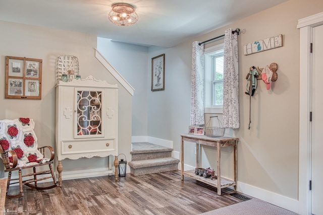 703 W Main St, Durand, MI 48429 - sitting room featuring baseboards, wood finished floors, and stairway