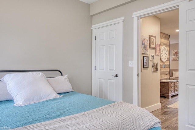 703 W Main St, Durand, MI 48429 - bedroom featuring wood finished floors and connected bathroom