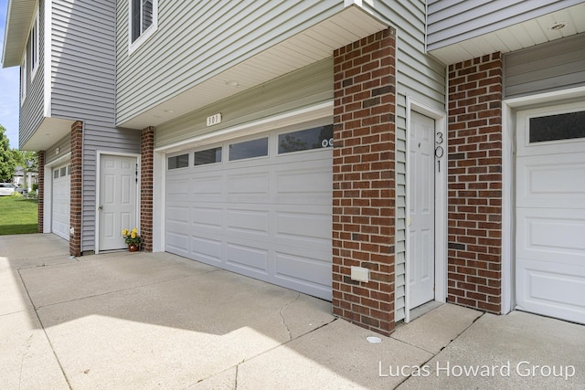 301 NW Xing Unit 25, Holland, MI 49423 - garage with concrete driveway