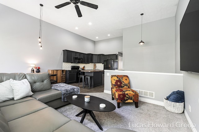 301 NW Xing Unit 25, Holland, MI 49423 - living room featuring ceiling fan, a towering ceiling, carpet floors, baseboards, and recessed lighting