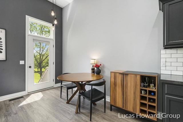 301 NW Xing Unit 25, Holland, MI 49423 - dining area with wood finished floors and baseboards