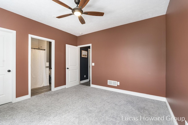 301 NW Xing Unit 25, Holland, MI 49423 - unfurnished bedroom featuring carpet, baseboards, ceiling fan, and ensuite bath