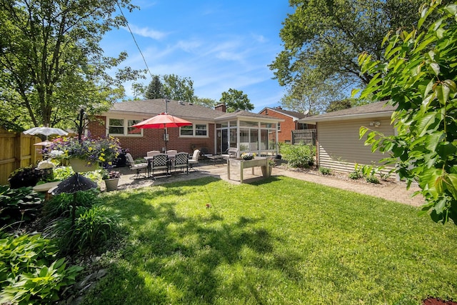 1537 Marian Ave, Ann Arbor, MI 48103 - back of house featuring a sunroom, a patio, and brick siding