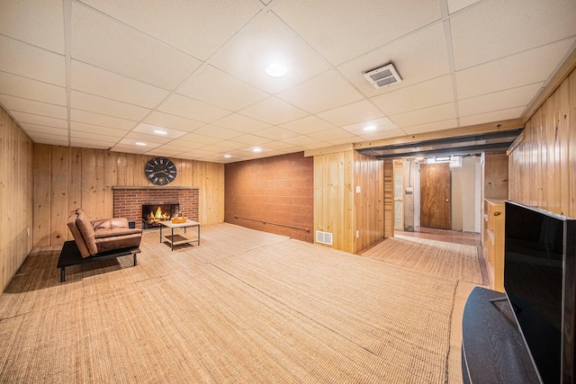 1537 Marian Ave, Ann Arbor, MI 48103 - sitting room featuring a fireplace, a drop ceiling, carpet floors, and wood walls