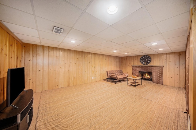 1537 Marian Ave, Ann Arbor, MI 48103 - unfurnished room with a drop ceiling, a fireplace, wood walls, and recessed lighting