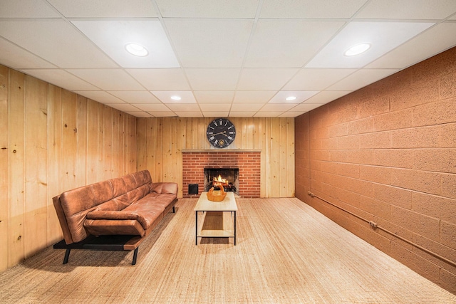 1537 Marian Ave, Ann Arbor, MI 48103 - living room with a brick fireplace, a paneled ceiling, wood walls, and recessed lighting