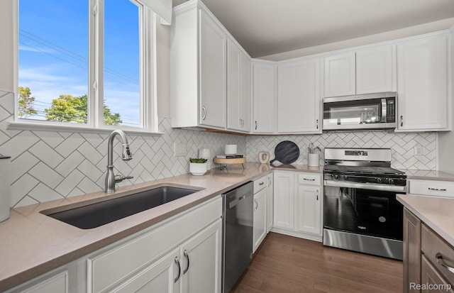42792 Arbor Dr, Clinton Township, MI 48038 - kitchen featuring stainless steel appliances, a sink, tasteful backsplash, and white cabinetry