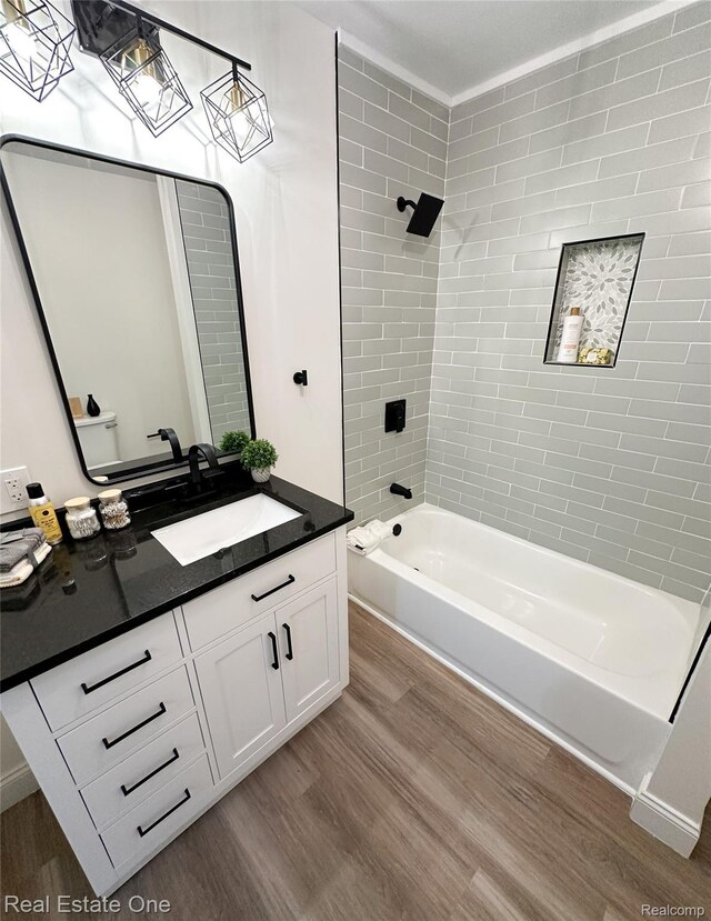 3504 Townsend St, Detroit, MI 48214 - bathroom featuring wood finished floors, vanity, toilet, and shower / washtub combination
