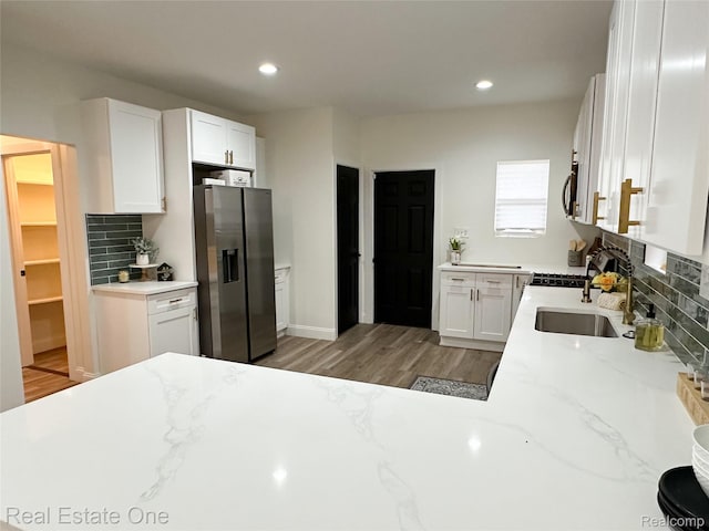 3504 Townsend St, Detroit, MI 48214 - kitchen featuring stainless steel appliances, a sink, tasteful backsplash, white cabinets, and recessed lighting