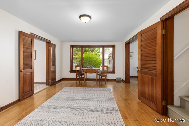 510 Division St, Big Rapids, MI 49307 - dining area with light wood-type flooring, baseboards, and stairway