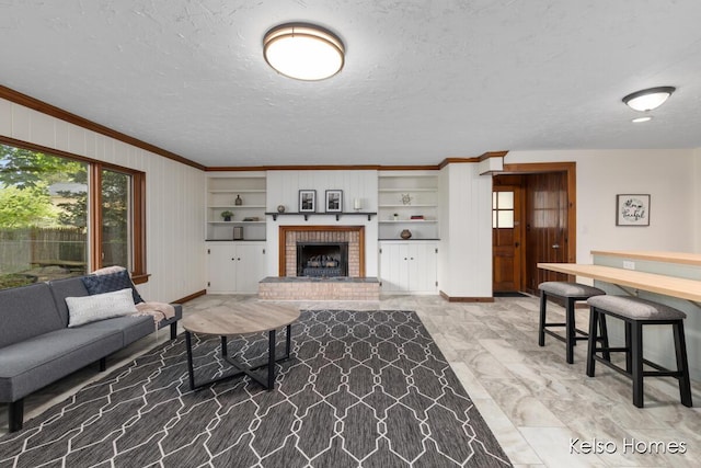 510 Division St, Big Rapids, MI 49307 - living room featuring ornamental molding, baseboards, a fireplace, a textured ceiling, and built in features