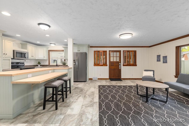 510 Division St, Big Rapids, MI 49307 - living room with crown molding, baseboards, a textured ceiling, light marble finish floors, and recessed lighting