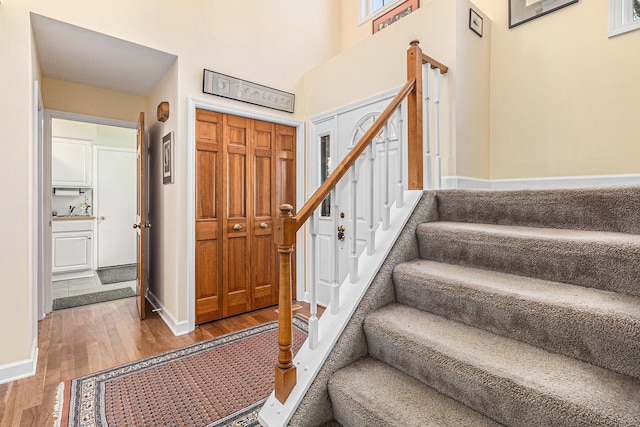 1336 Coventry Square Dr, Ann Arbor, MI 48103 - foyer entrance featuring wood finished floors, stairway, baseboards, and a towering ceiling