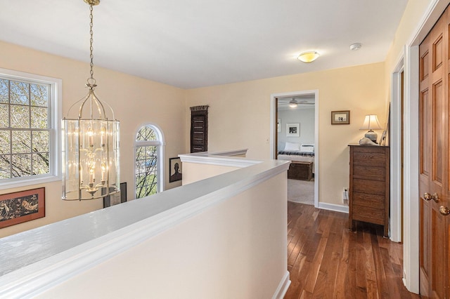 1336 Coventry Square Dr, Ann Arbor, MI 48103 - hallway with a chandelier, dark wood-style floors, baseboards, and an upstairs landing