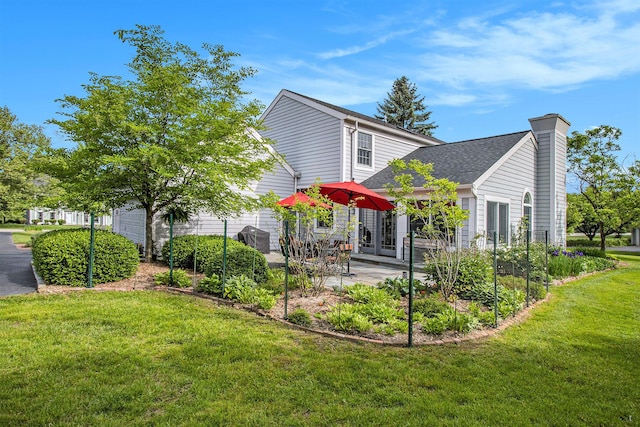 1336 Coventry Square Dr, Ann Arbor, MI 48103 - back of property featuring a yard, a chimney, a patio area, and french doors