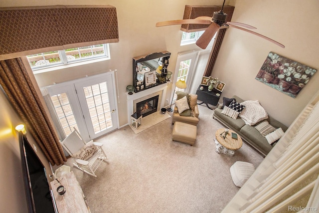 5886 Augusta Ln, Grand Blanc, MI 48439 - carpeted living room featuring a towering ceiling, ceiling fan, and a high end fireplace