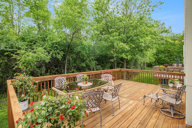 5886 Augusta Ln, Grand Blanc, MI 48439 - wooden terrace featuring outdoor dining area and view of wooded area