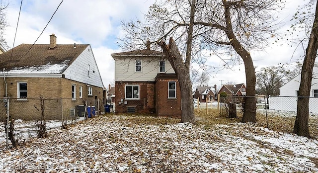 15827 Tracey St, Detroit, MI 48227 - snow covered house featuring brick siding and a chimney