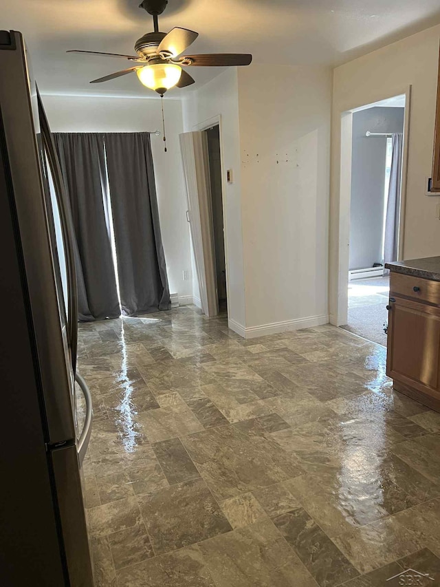 19400 Charest Ave, Detroit, MI 48234 - spare room with ceiling fan, baseboards, and dark stone finish flooring