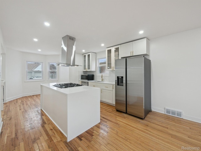 18212 Sorrento St, Detroit, MI 48235 - kitchen with island range hood, stainless steel fridge with ice dispenser, black microwave, a sink, and gas stovetop