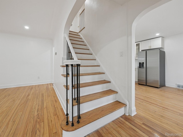 18212 Sorrento St, Detroit, MI 48235 - stairway with arched walkways, wood finished floors, recessed lighting, and baseboards