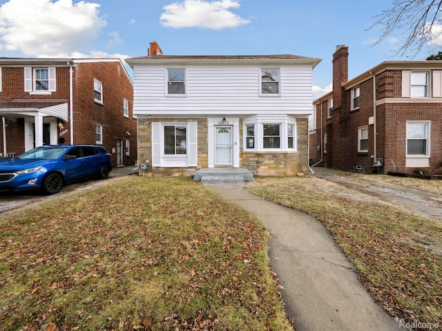 18212 Sorrento St, Detroit, MI 48235 - multi unit property with stone siding, a front lawn, and a chimney