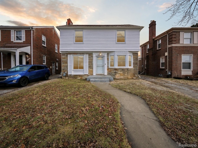 18212 Sorrento St, Detroit, MI 48235 - townhome / multi-family property featuring stone siding and a front yard