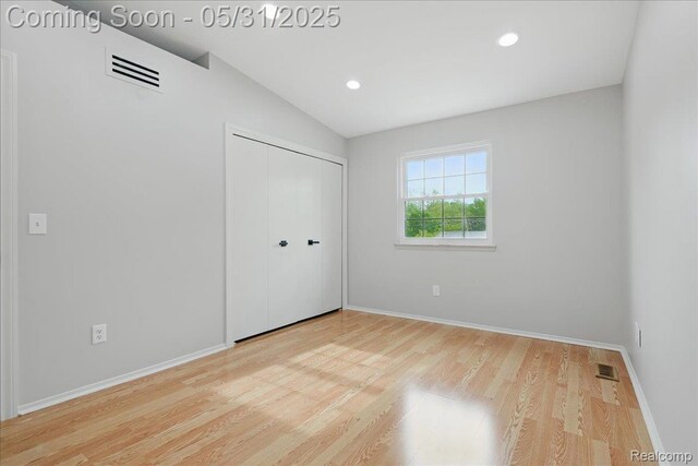 3004 Lansdowne Rd, Waterford, MI 48329 - unfurnished bedroom featuring vaulted ceiling, wood finished floors, a closet, baseboards, and recessed lighting