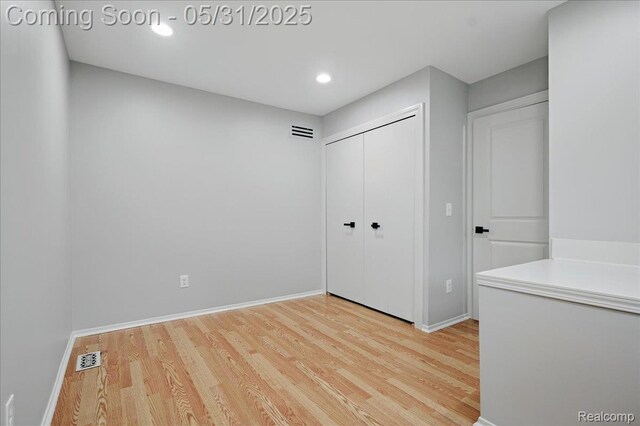 3004 Lansdowne Rd, Waterford, MI 48329 - unfurnished bedroom with wood finished floors, baseboards, a closet, and recessed lighting