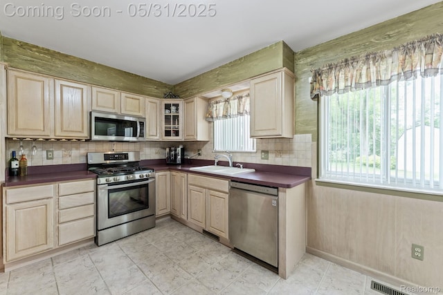 9220 Garden Ter, Commerce Twp, MI 48382 - kitchen featuring appliances with stainless steel finishes, a sink, dark countertops, and light brown cabinets