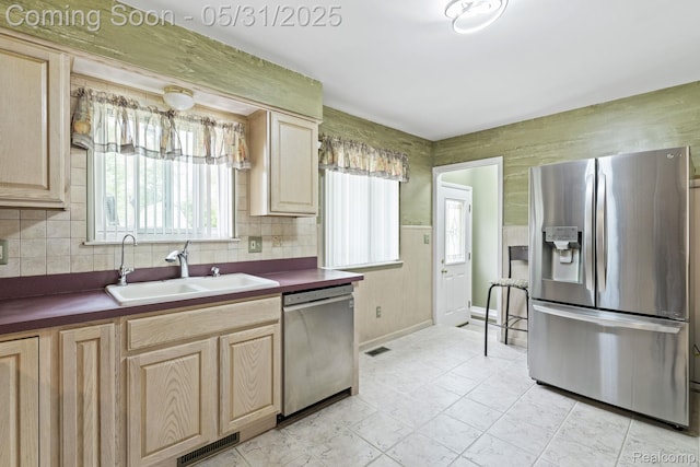 9220 Garden Ter, Commerce Twp, MI 48382 - kitchen with stainless steel appliances, light brown cabinetry, dark countertops, and a sink