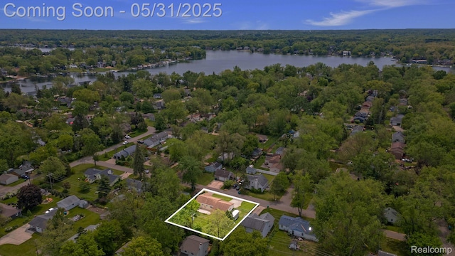 9220 Garden Ter, Commerce Twp, MI 48382 - aerial view of property's location with a nearby body of water, a heavily wooded area, property parcel outlined, and nearby suburban area