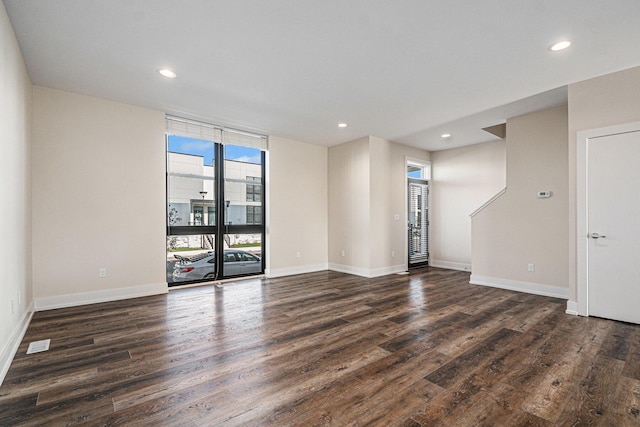 6016 Port View Dr SE, Grand Rapids, MI 49512 - spare room with dark wood-type flooring, recessed lighting, baseboards, and a wall of windows