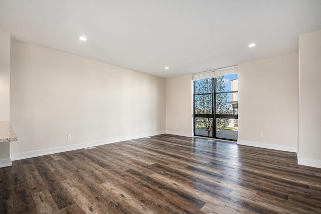 6016 Port View Dr SE, Grand Rapids, MI 49512 - unfurnished room with dark wood-type flooring, a wall of windows, baseboards, and recessed lighting