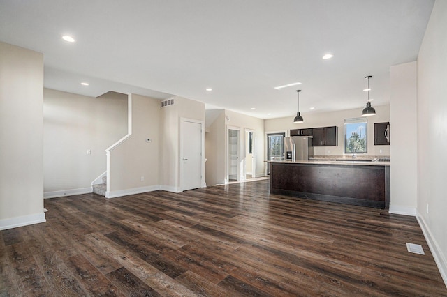 6016 Port View Dr SE, Grand Rapids, MI 49512 - unfurnished living room with dark wood finished floors, baseboards, stairs, and recessed lighting