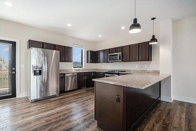 6016 Port View Dr SE, Grand Rapids, MI 49512 - kitchen featuring stainless steel appliances, dark brown cabinetry, a peninsula, dark wood-type flooring, and recessed lighting