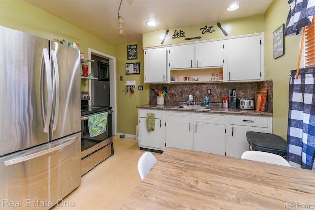 540 Champaign Rd, Lincoln Park, MI 48146 - kitchen with stainless steel appliances, light flooring, a sink, tasteful backsplash, and open shelves