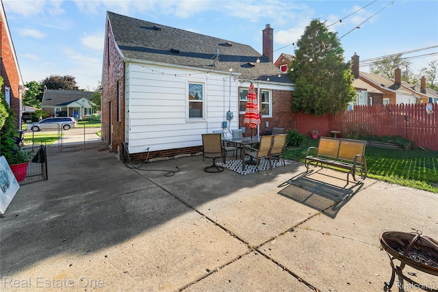 540 Champaign Rd, Lincoln Park, MI 48146 - back of house with a patio, outdoor dining area, an outdoor fire pit, a gate, and a shingled roof