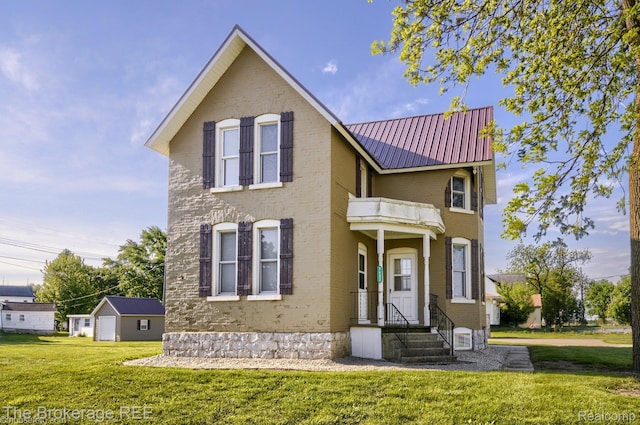 9425 W Saginaw Rd, Richville, MI 48758 - view of front of home featuring a balcony, a front lawn, brick siding, and metal roof