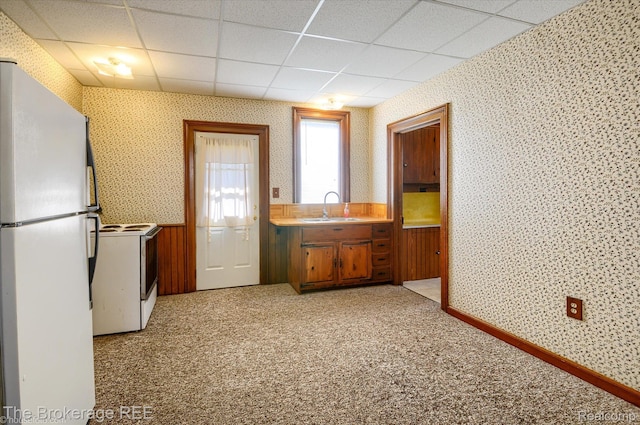 9425 W Saginaw Rd, Richville, MI 48758 - kitchen featuring white appliances, wallpapered walls, a sink, light colored carpet, and a drop ceiling