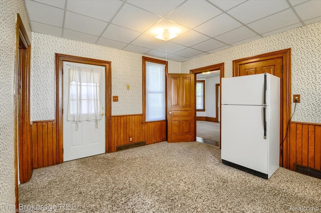 9425 W Saginaw Rd, Richville, MI 48758 - kitchen with freestanding refrigerator, a wainscoted wall, a paneled ceiling, wallpapered walls, and wood walls